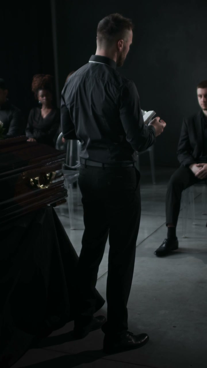 Man Speaking at Funeral Service
