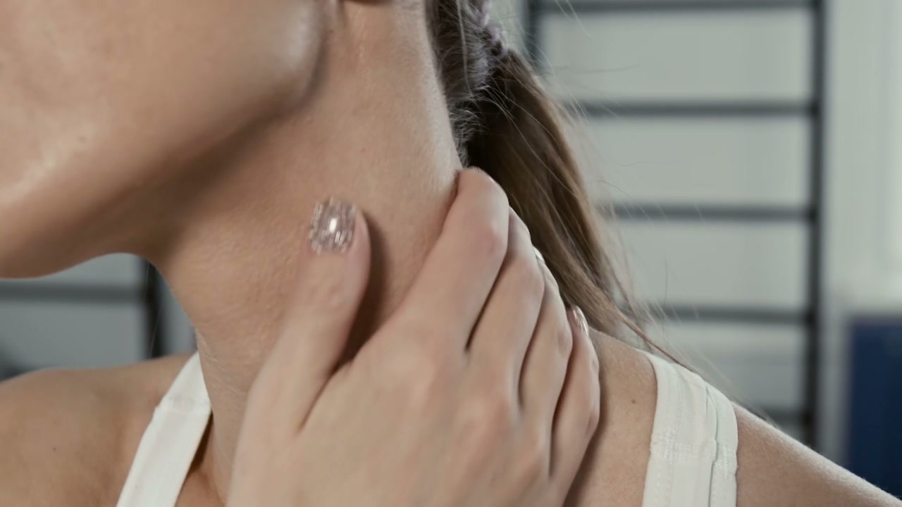 Woman Massaging Her Neck in Discomfort