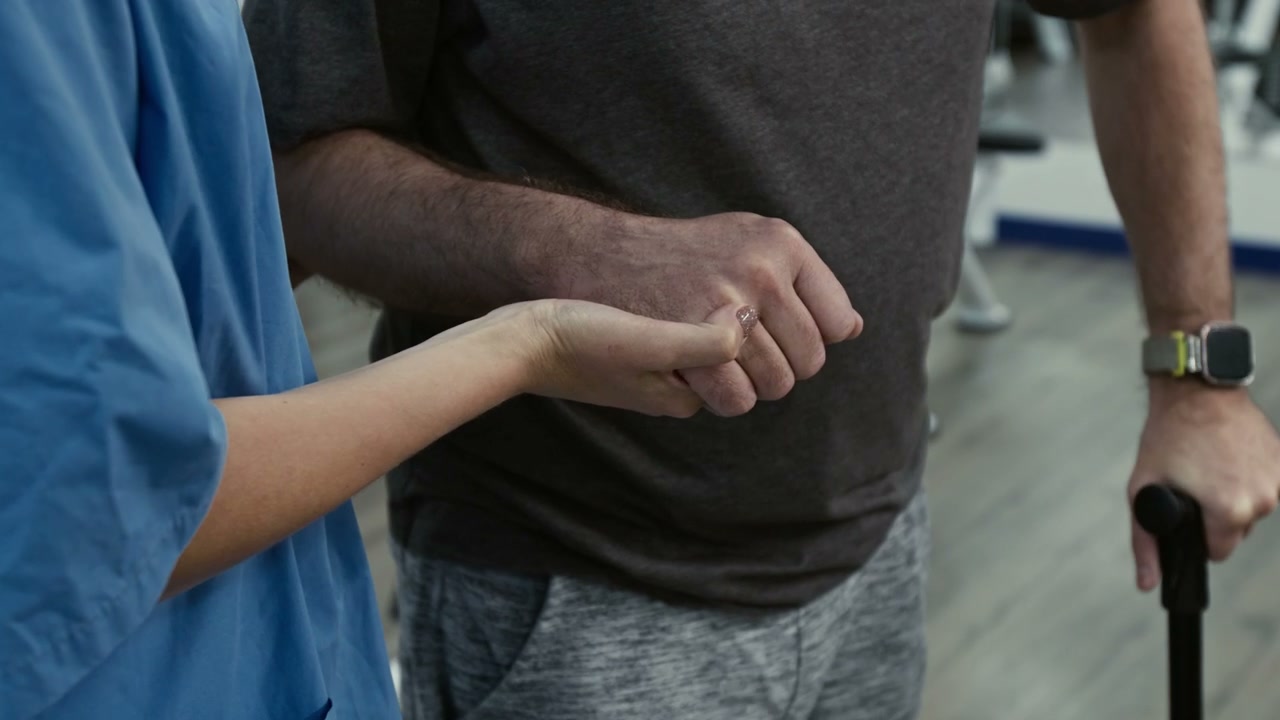 Physiotherapist Helps Patient Walk with Cane