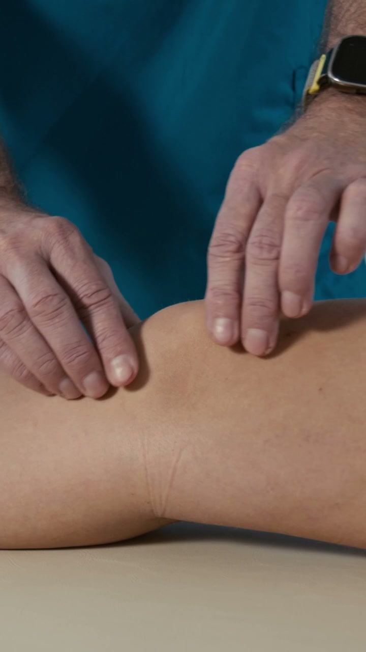 Physiotherapist Examining Patient's Knee