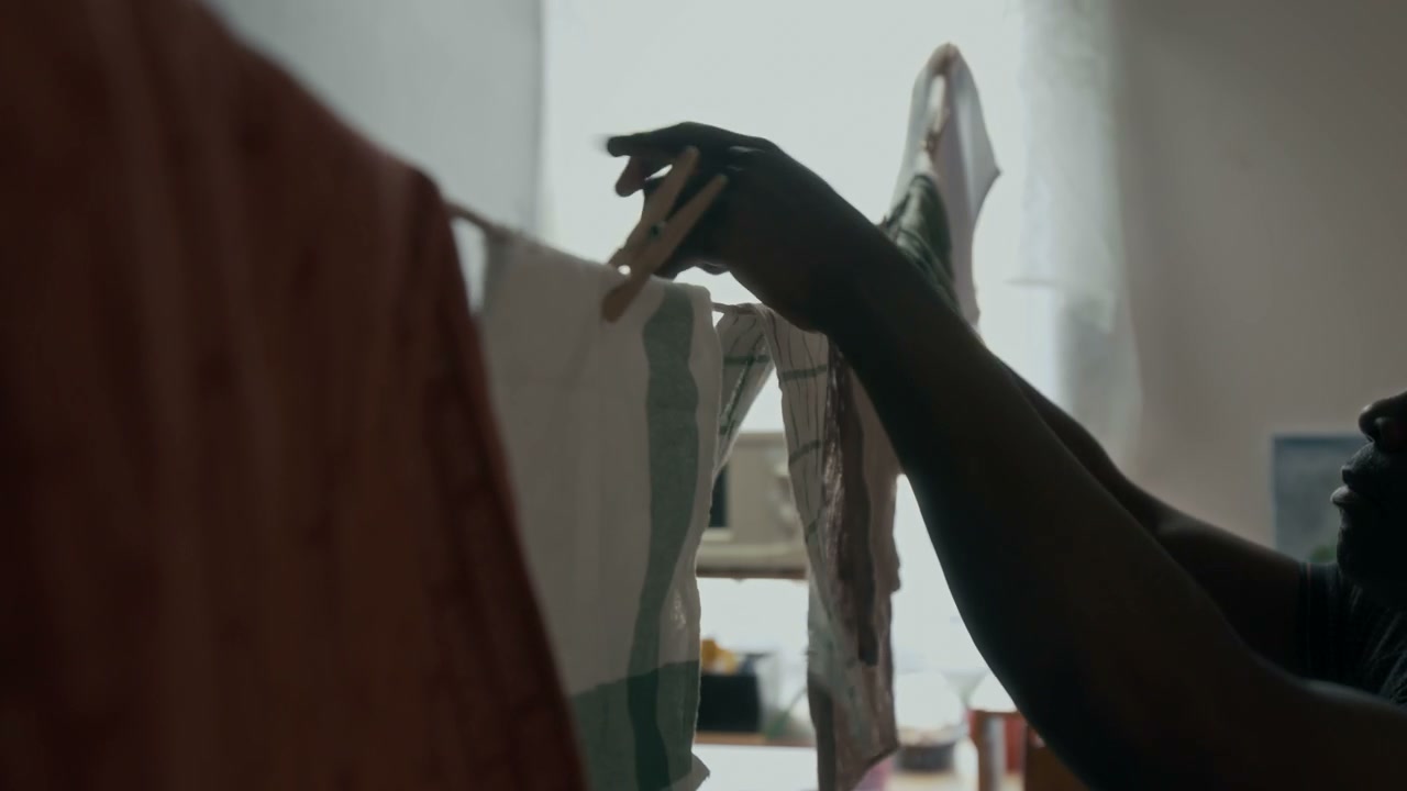 Person Hanging Laundry Indoors