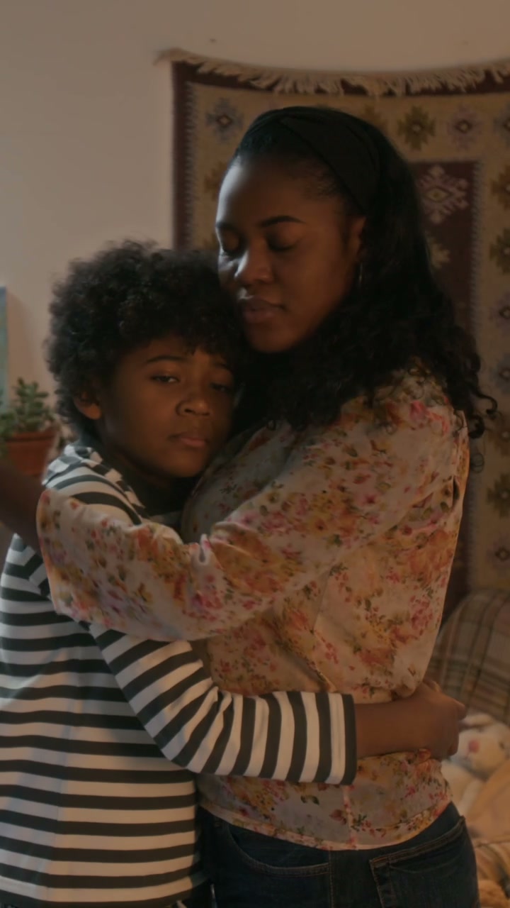 Mother and Son Embrace Looking at Camera