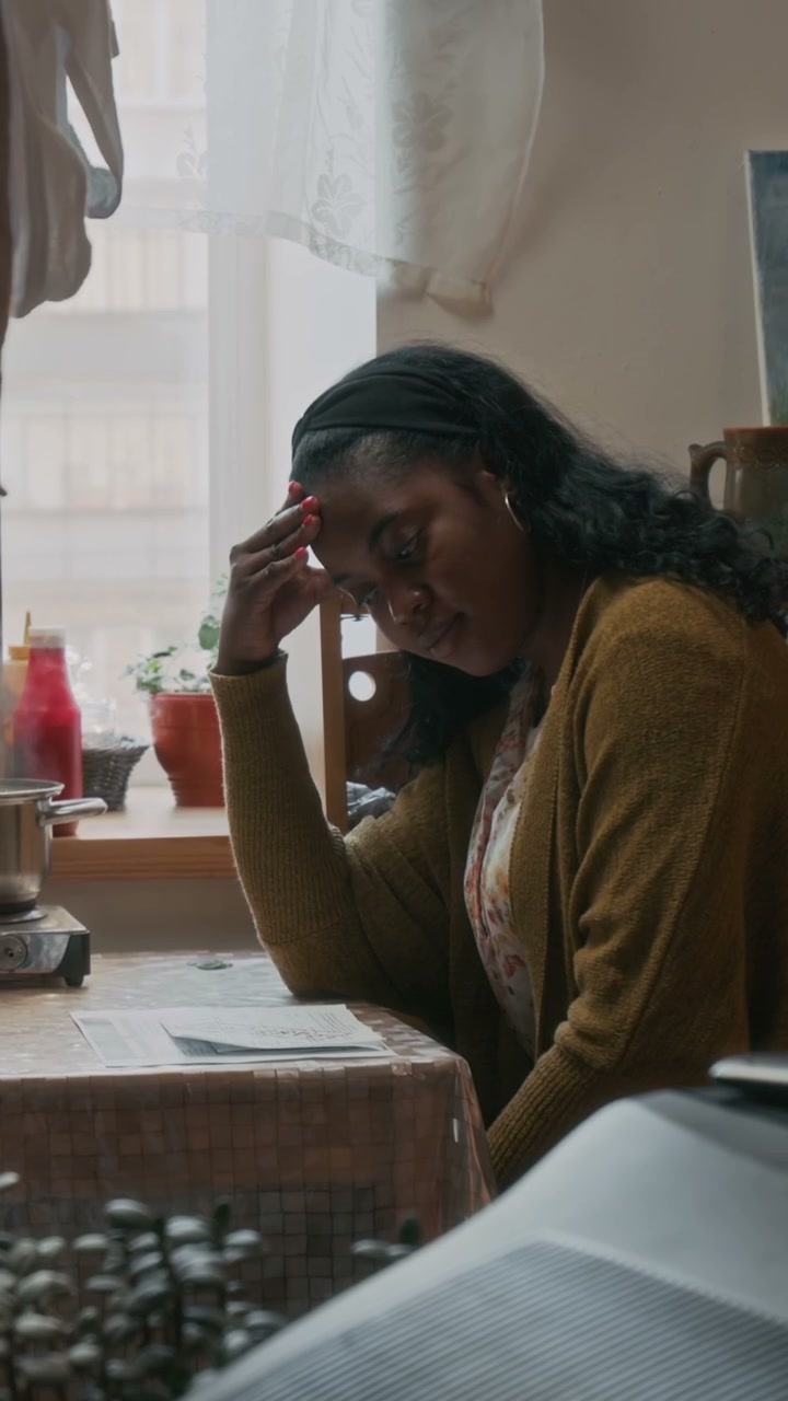 Stressed Person Reviewing Bills at Home