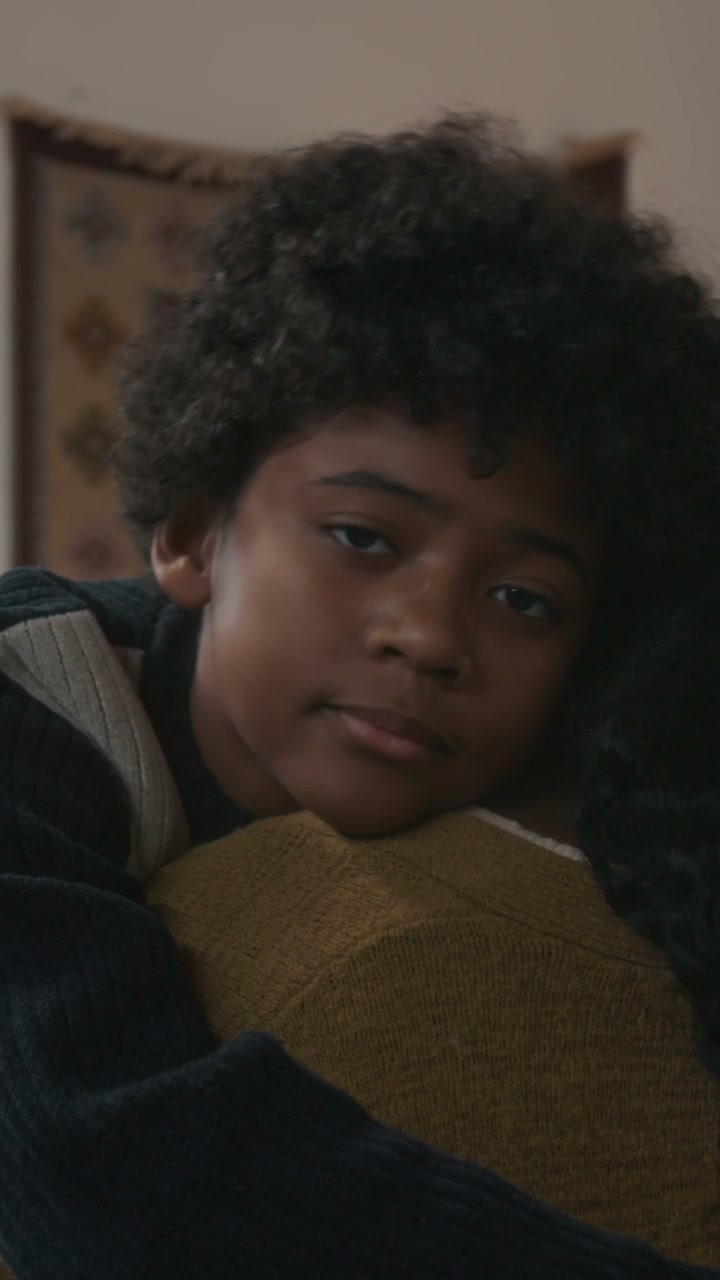 Boy Hugs Adult Affectionately at Home