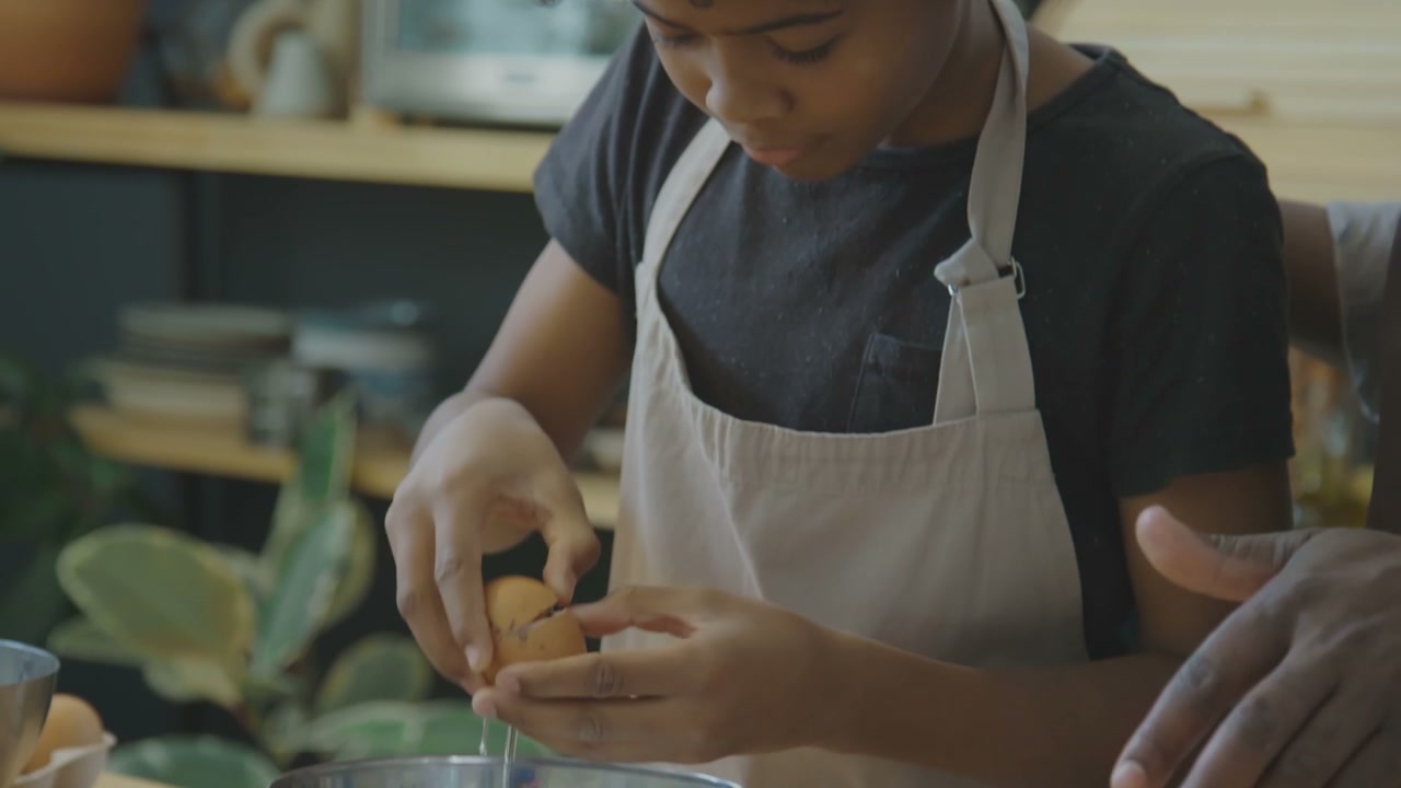 Boy Cracking Egg in Kitchen