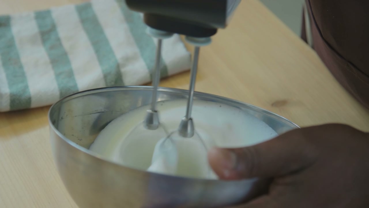 Electric Mixer Whipping Cream in Kitchen