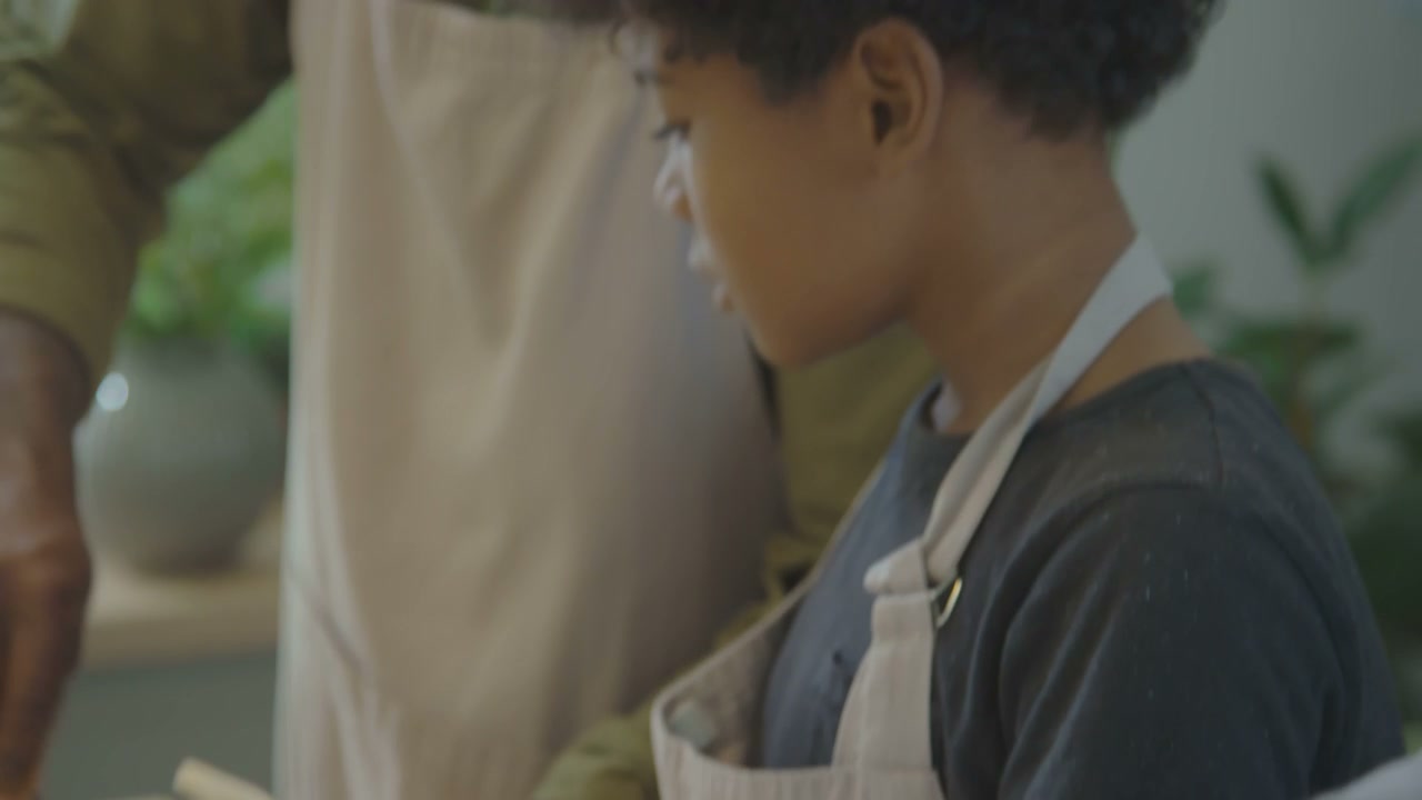 Boy Reading Cookbook While Cooking