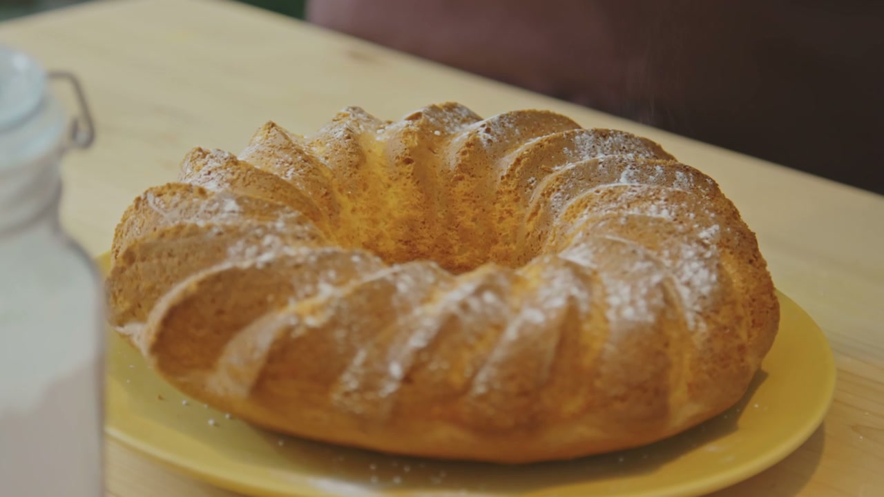 Dusting Powdered Sugar on a Baked Ring Cake