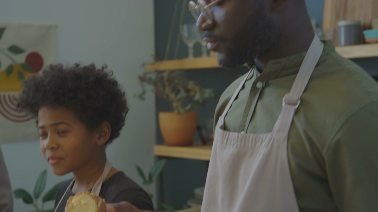 Man Eating Slice of Cake in Kitchen