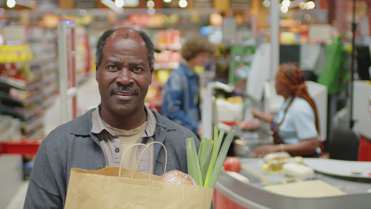 Smiling Senior Customer at Supermarket Checkout