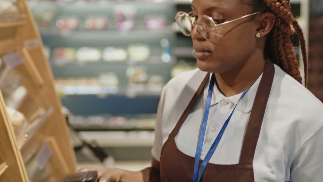 Supermarket Worker Scanning Bakery Products