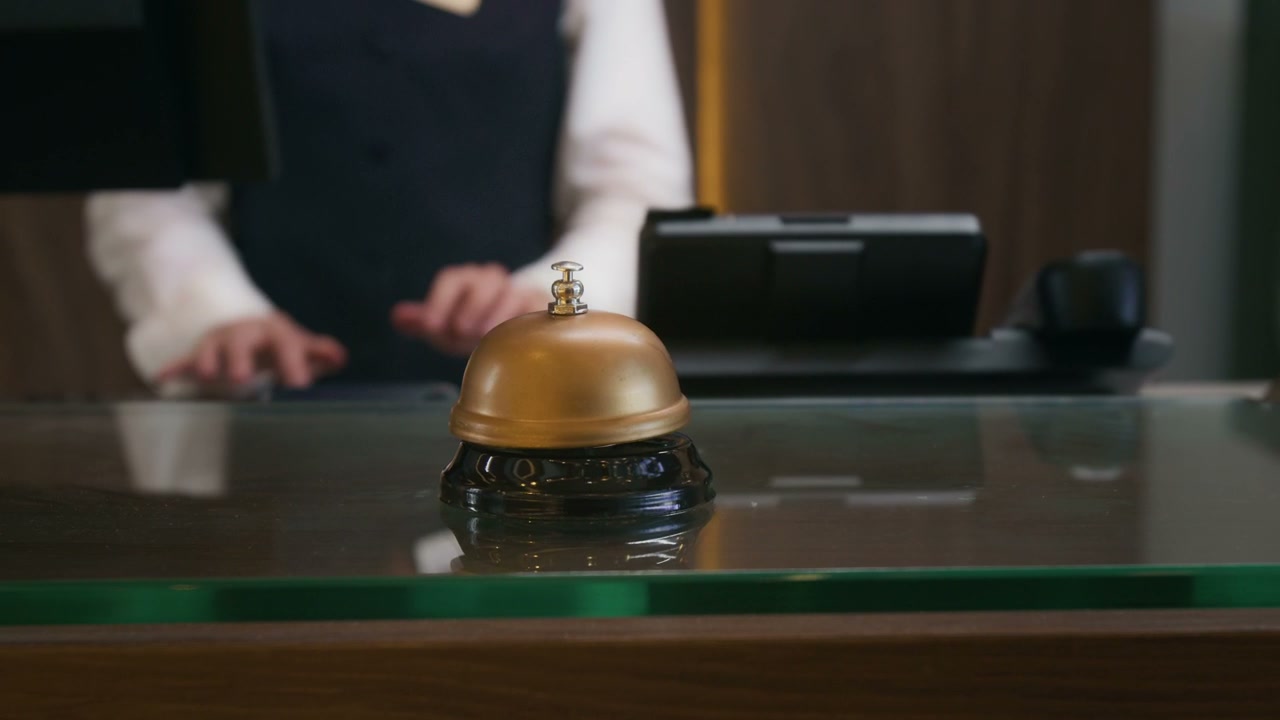 Hotel Employee Answering Phone Call at Front Desk