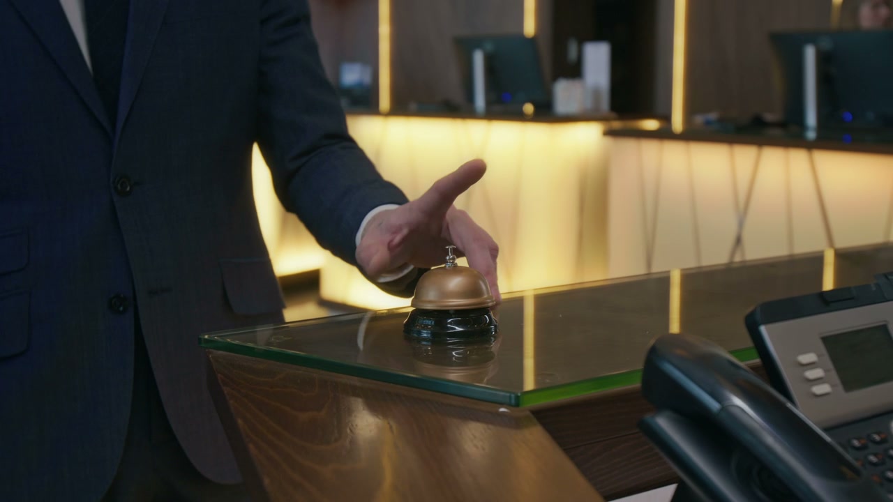 Man Ringing Hotel Service Bell