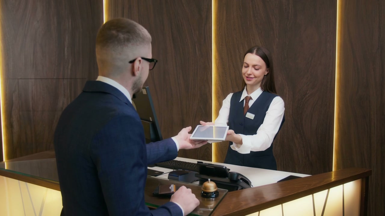 Guest Signing on Tablet at Hotel Reception