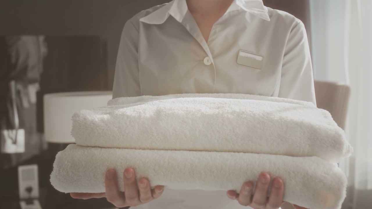 Hotel Employee Holding Fresh Towels