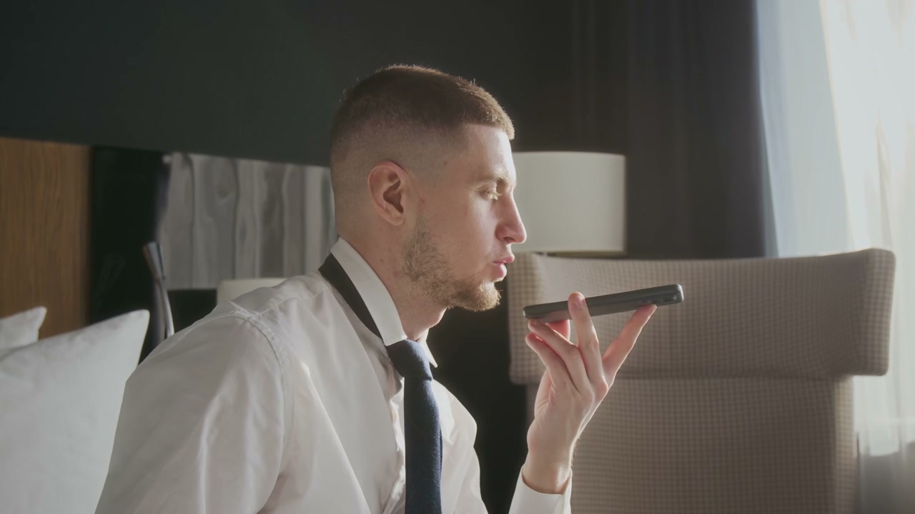 Businessman Speaking on Phone in Hotel Room
