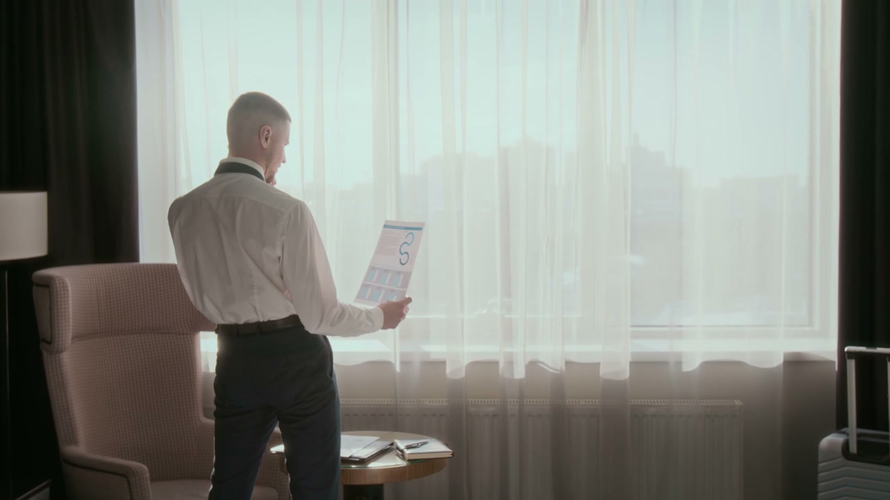 Businessman on Phone Call in Hotel Room