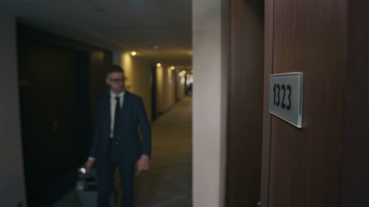 Businessman Enters Hotel Room with Keycard