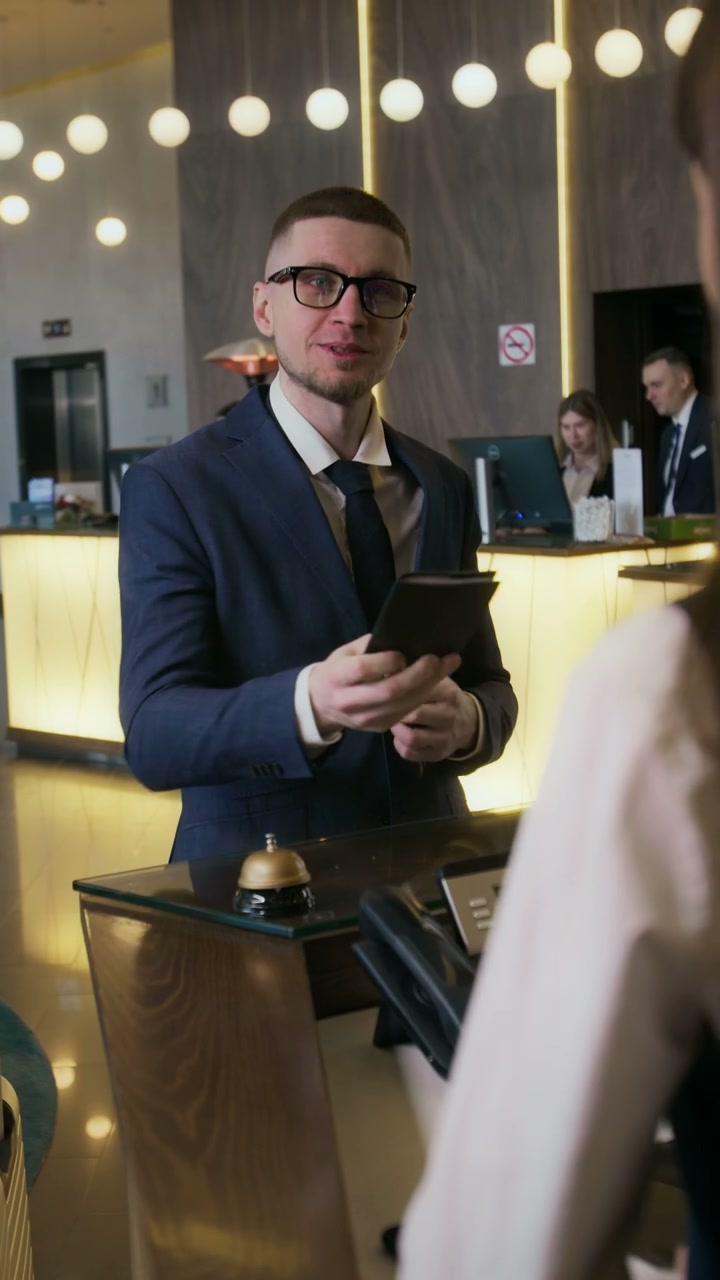 Businessman Checking In At Hotel Reception