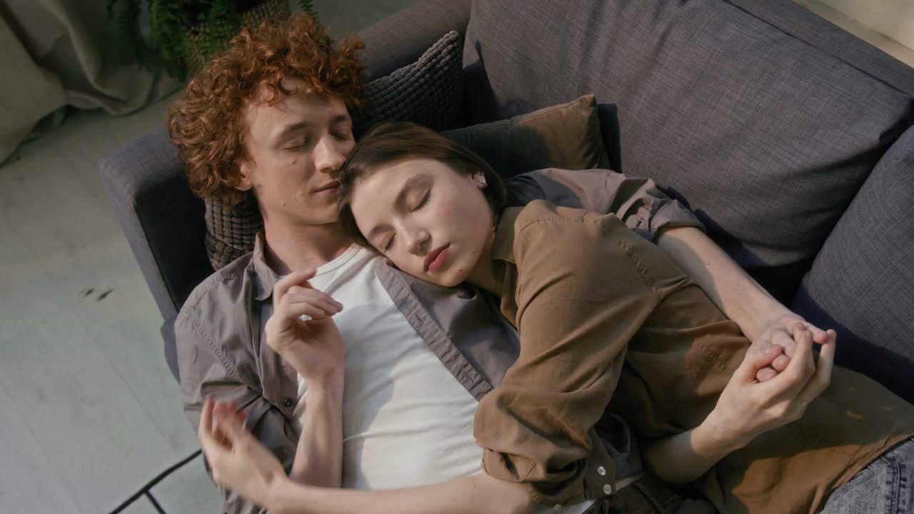 Romantic Couple Cuddling on Sofa at Home
