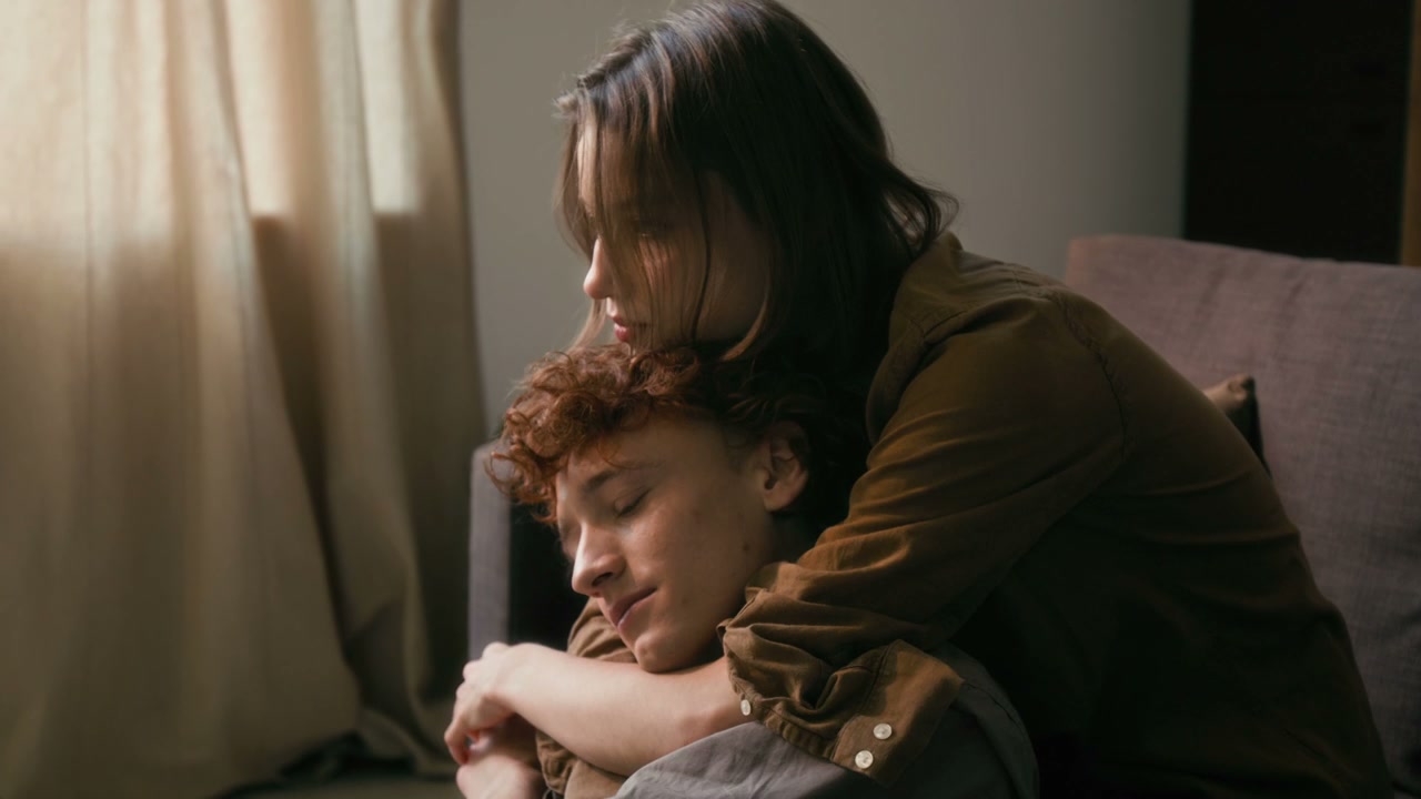 Romantic Couple Embracing on Sofa at Home