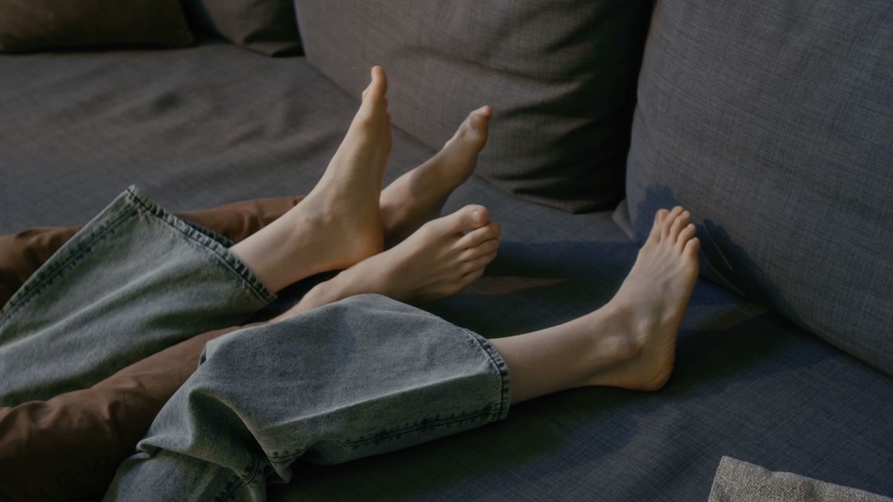 Romantic Couple's Feet on Couch