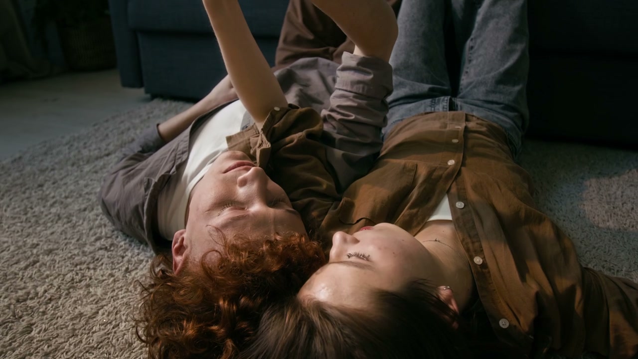 Romantic Couple Cuddling on Living Room Floor