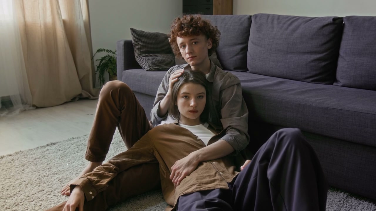 Affectionate Couple Relaxing on Living Room Floor