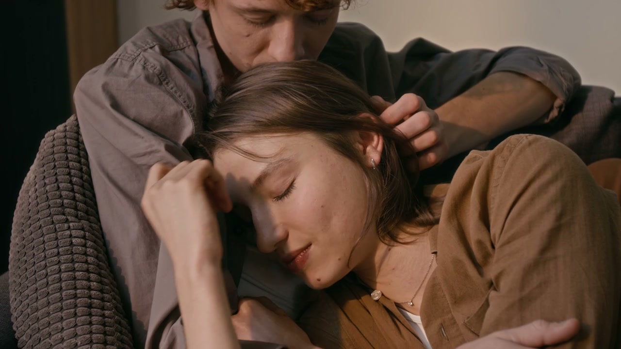Romantic Couple Cuddling on Sofa