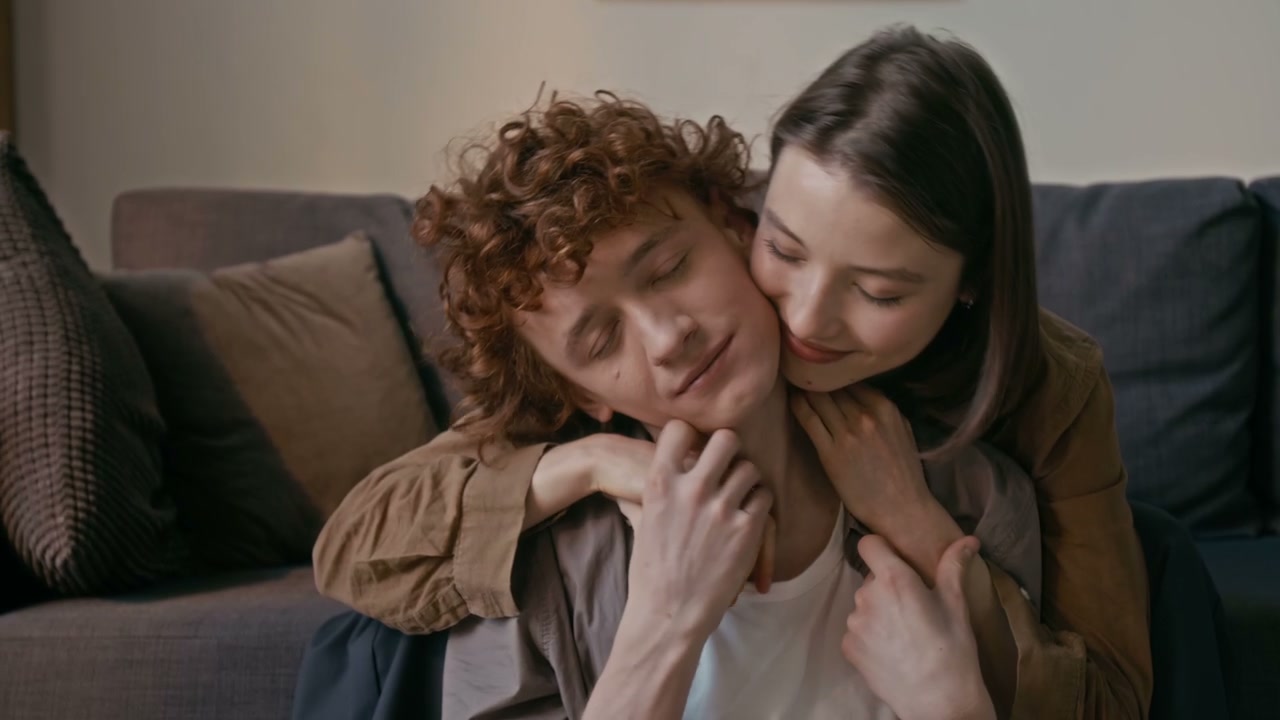 Couple Cuddling and Kissing at Home