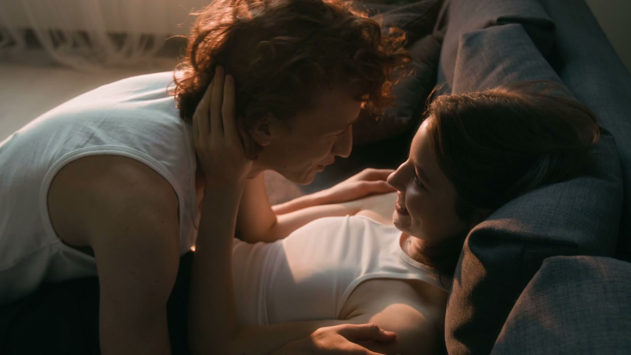 Affectionate Couple Embracing on Sofa