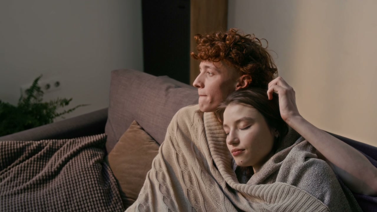 Romantic Couple Relaxing on Sofa at Home