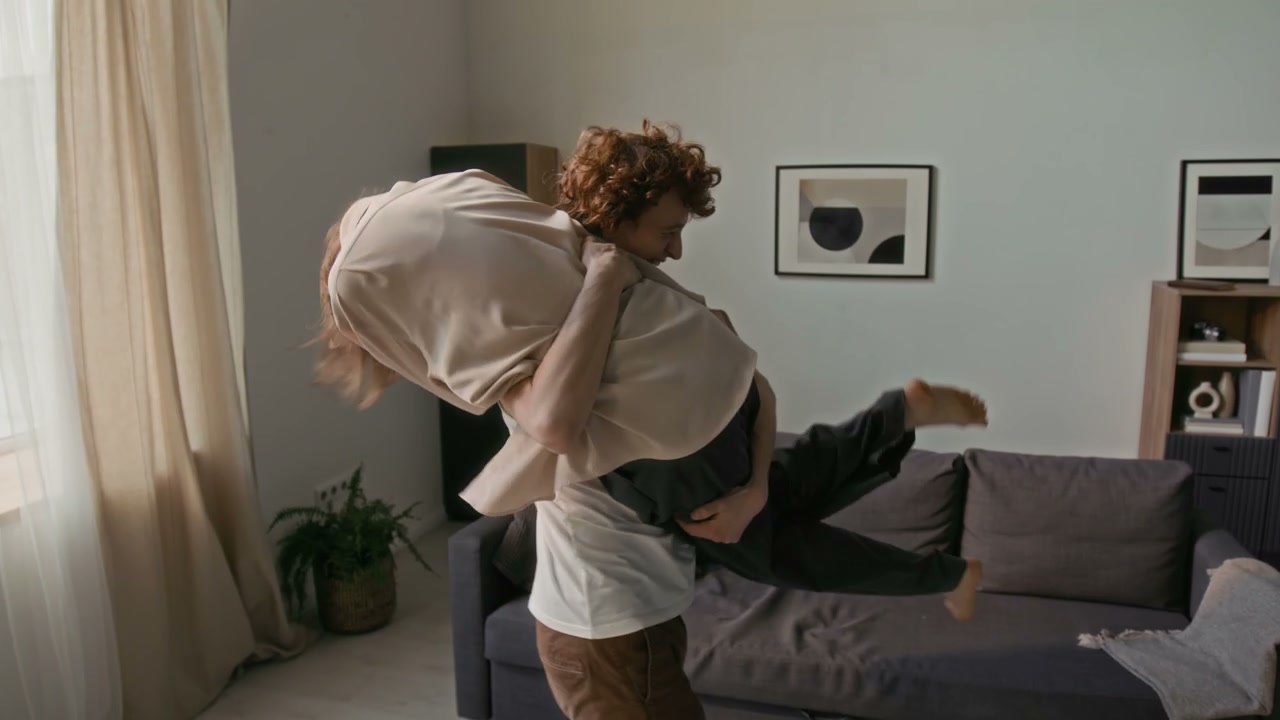 Playful Romantic Couple Spinning at Home