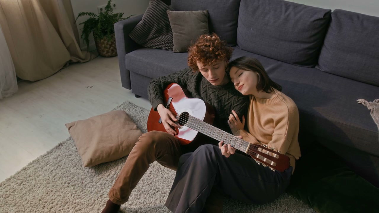 Romantic Couple Playing Guitar at Home