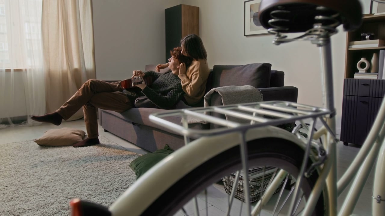 Affectionate Couple Relaxing on Living Room Sofa