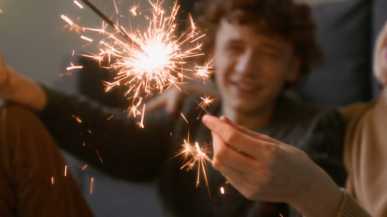 Happy Couple Holding Sparklers at Home