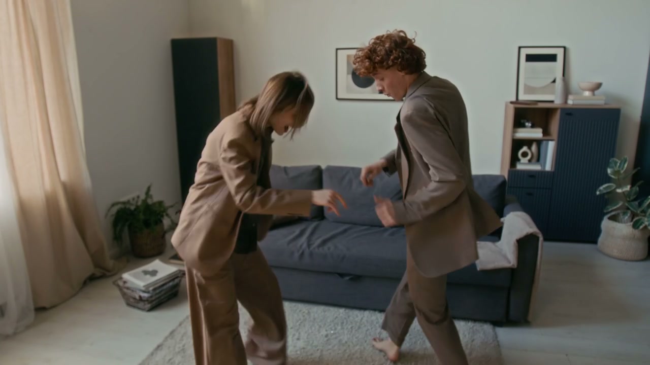 Energetic Couple Dancing in Living Room