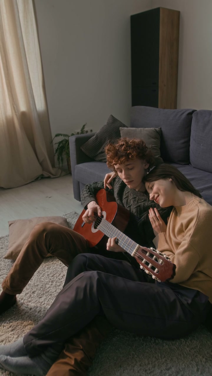 Romantic Couple Playing Guitar at Home