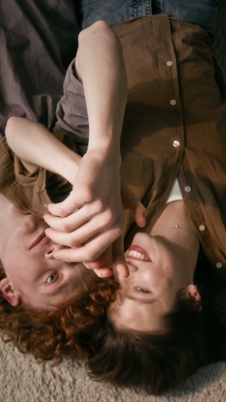 Romantic Couple Playfully Holding Hands