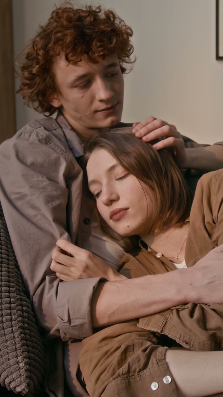 Romantic Couple Cuddling on Sofa at Home