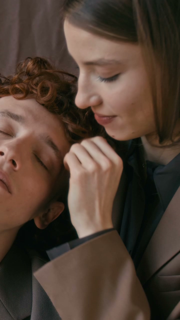 Woman Gently Caresses Man's Face