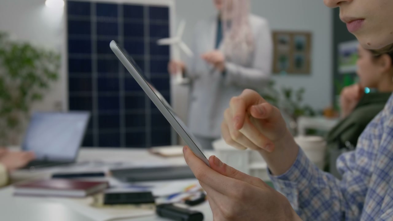 Person Using Tablet in Sustainable Office