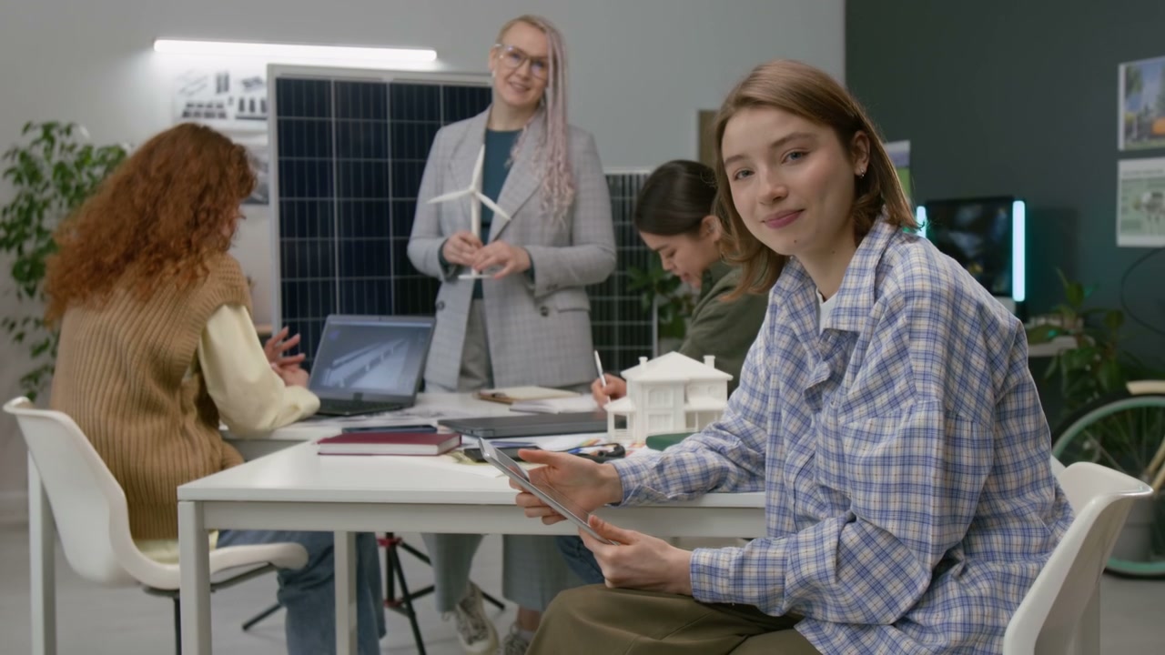 Young Woman Smiling in Green Energy Office