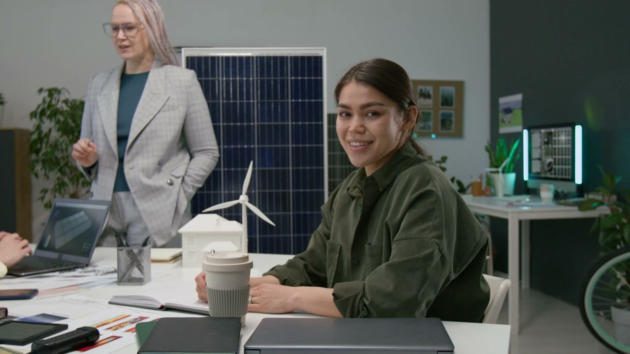 Young Woman Smiling in Renewable Energy Office
