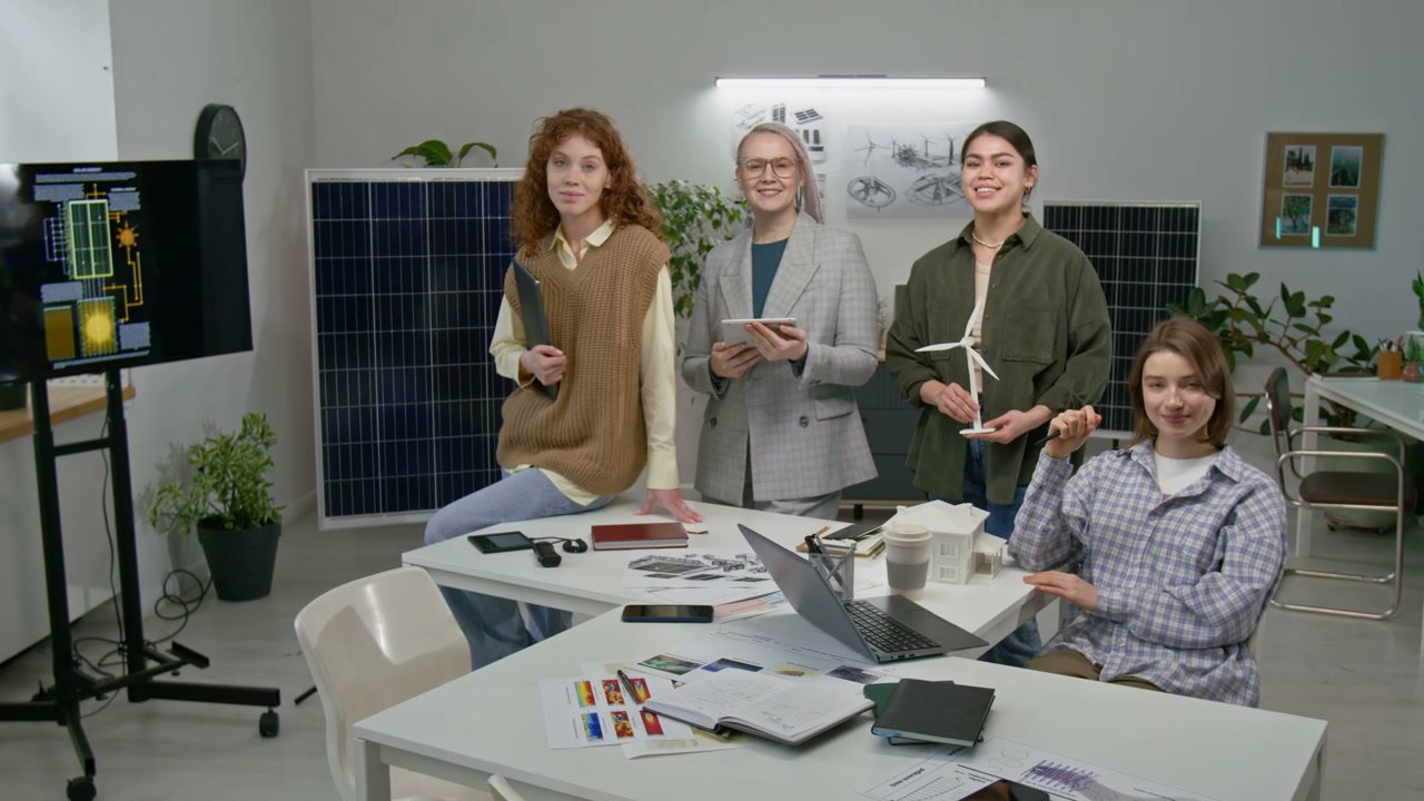 Women Engineers Posing in Green Energy Office