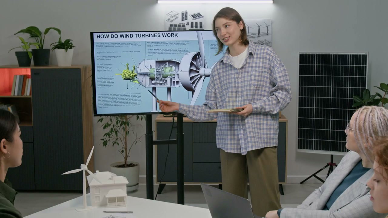 Woman Explains Wind Turbine Design to Team