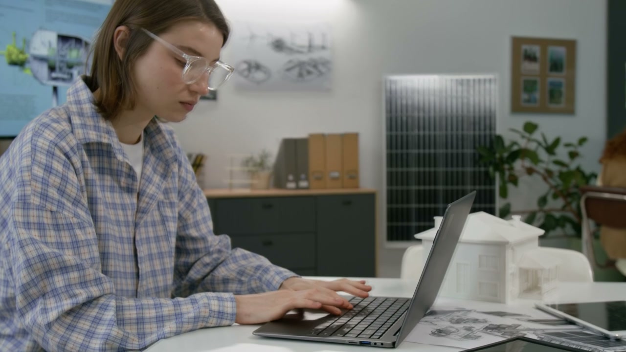Female Engineer Working on Laptop in Office
