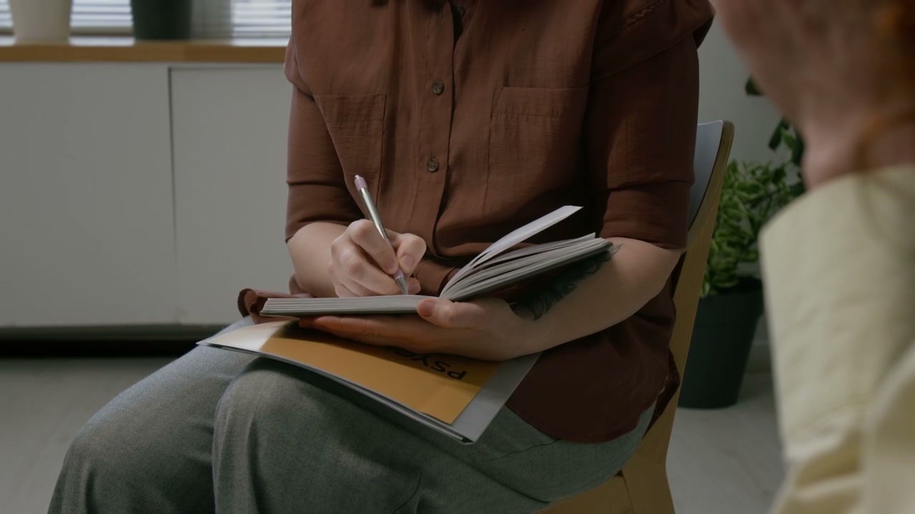 Therapist Taking Notes During Therapy Session