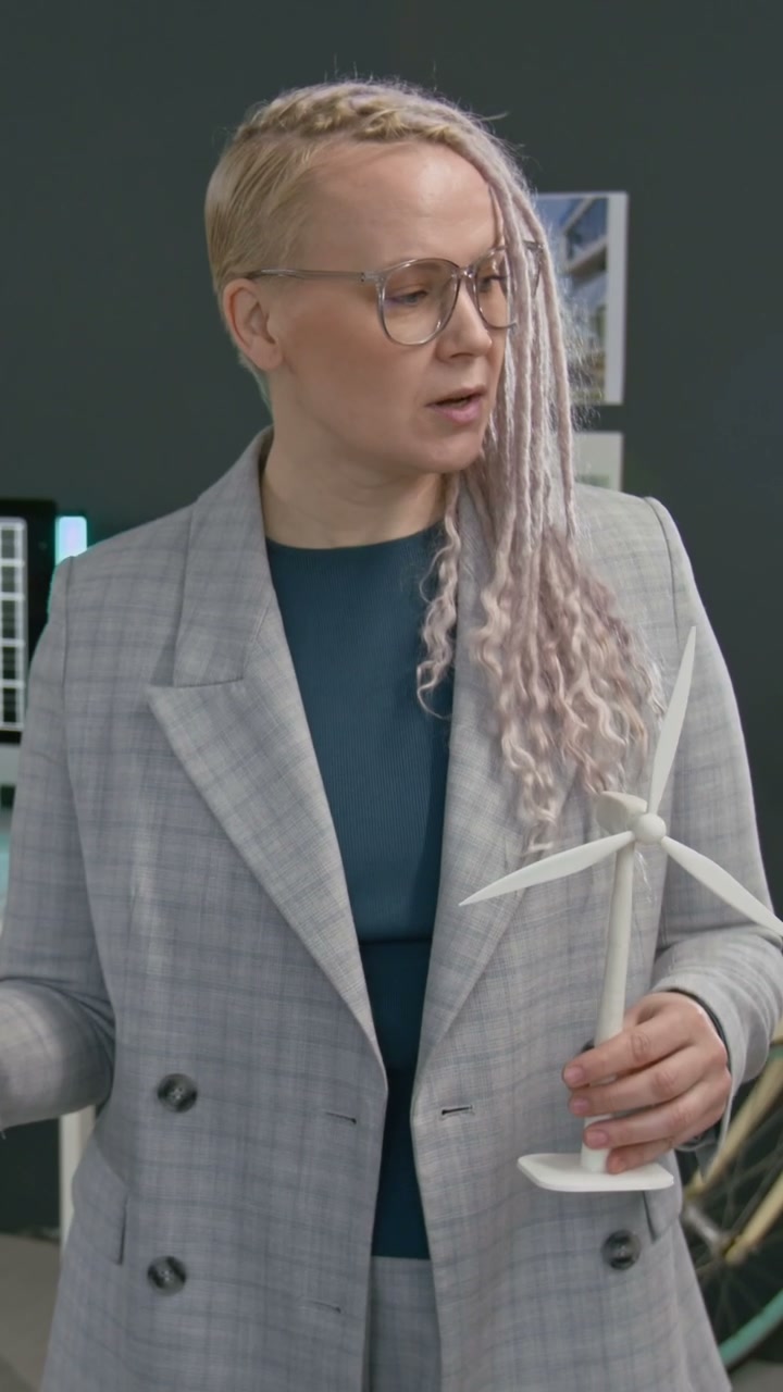 Professional Woman Presenting Wind Turbine Model