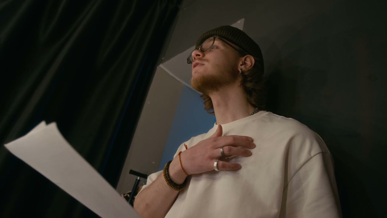 Comedian Rehearsing with Script Backstage